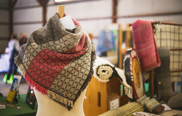 Vendor booth featured with shawl on display.